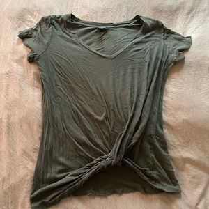 Dark V neck short sleeved t shirt with twist detail at bottom